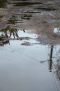 Photo of a fragment of a destroyed road with large puddles in rainy weathe