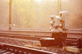 Photo of a fragment of a railway track with a small traffic light in rainy weathe Royalty Free Stock Photo