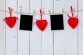 Photo frame blank and red heart hanging on white wood background Royalty Free Stock Photo