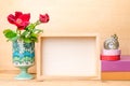 Photo frame with books and flowers on the wooden table Royalty Free Stock Photo