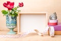 Photo frame with books and flowers on the wooden table Royalty Free Stock Photo
