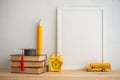 Photo frame and books, graducation hat, pencil, alarm clock, stu