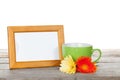 Photo frame with cup of coffee and gerbera flowers Royalty Free Stock Photo