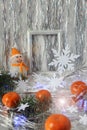 Photo frame with an elegant snowman , bright tangerines and Christmas tinsel, side view, vertical frame