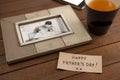 Photo frame, lemon tea and card on wooden plank