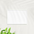 Photo frame mockup on white wall. Poster mockup. Clean, modern, minimal frame. Minimalist background. Blank picture frame mockup. Royalty Free Stock Photo