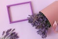 Photo frame on a pastel background with lavender bouquets, space for text, top view