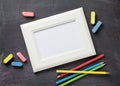 Photo frame and school supplies on blackboard background Royalty Free Stock Photo