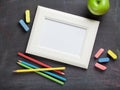 Photo frame and school supplies on blackboard background Royalty Free Stock Photo