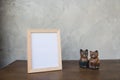 Photo Frame and toy cat on a wooden on Gray wall background . Royalty Free Stock Photo