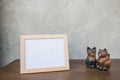 Photo Frame and toy cat on a wooden on Gray wall background . Royalty Free Stock Photo