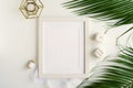 Photo frame of white color mockup, interior items and palm branches Royalty Free Stock Photo