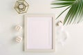 Photo frame of white color mockup, interior items and palm branches Royalty Free Stock Photo