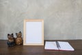 Photo Frame on a wooden table and book and toy cat Royalty Free Stock Photo