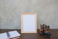 Photo Frame on a wooden table and book and toy cat Royalty Free Stock Photo