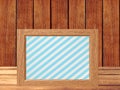 Photo frame on wooden table over wooden background Royalty Free Stock Photo