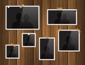 Photo frames attached with adhesive tape and thumbtacks on wood background. Vector. Royalty Free Stock Photo