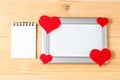 Photo frames, blank card and handmade hearts over wooden background Royalty Free Stock Photo