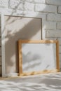 Photo frames on floor over white brick wall Royalty Free Stock Photo