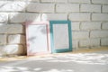 Photo frames on floor over white brick wall Royalty Free Stock Photo