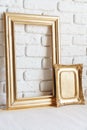 Photo frames on floor over white brick wall Royalty Free Stock Photo