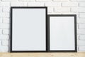 Photo frames on floor over white brick wall Royalty Free Stock Photo