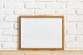 Photo frames on floor over white brick wall Royalty Free Stock Photo