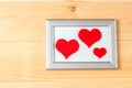 Photo frames and handmade hearts over wooden background Royalty Free Stock Photo