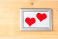 Photo frames and handmade hearts over wooden background Royalty Free Stock Photo