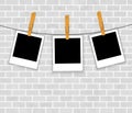 Photo frames on rope with clothespins on brick wal Royalty Free Stock Photo