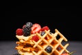 Photo of fresh viennese waffles with berries pouring honey against blank background Royalty Free Stock Photo