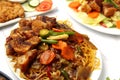 Filipino dish called Pancit Canton topped with Lechon Kawali and mixed vegetables