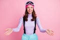 Photo of friendly curly young lady skier dressed jumper headwear goggles inviting you open arms isolated pink color
