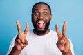 Photo of friendly guy toothy beaming smile show v-sign on blue background