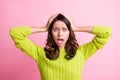 Photo of frightened anxious young girl open mouth palms head wear green pullover isolated pink color background