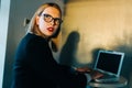 Photo of frightened woman with glasses with laptop