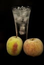 Photo of frozen apples and glasses with ice on a black background