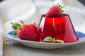 Photo of fruit jelly with fresh strawberry. Healthy food. Strawberry jelly on white plate. Summer dessert with fruit Royalty Free Stock Photo