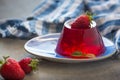 Photo of fruit jelly with fresh strawberry. Healthy food. Strawberry jelly on white plate. Summer dessert with fruit Royalty Free Stock Photo