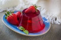 Photo of fruit jelly with fresh strawberry. Healthy food. Strawberry jelly on white plate. Summer dessert with fruit Royalty Free Stock Photo