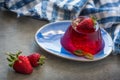 Photo of fruit jelly with fresh strawberry. Healthy food. Strawberry jelly on white plate. Summer dessert with fruit Royalty Free Stock Photo