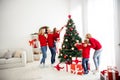 Photo of full big family five people gathering three small kids dad hold help daughter decorate x-mas tree tinsel