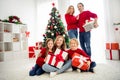 Photo of full big family five people gathering three small kids hold presents cuddle parents dad hold bag toys wear red Royalty Free Stock Photo