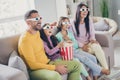 Photo of full big family four people sit couch eat pop corn watch movie wear 3d glasses colorful jumper pants in living Royalty Free Stock Photo