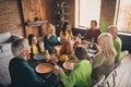 Photo of full family eight members gathering sit two little kids hold hands eyes closed pray thank god rich harvest Royalty Free Stock Photo