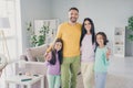 Photo of full family four members gathering two little kids hug show v-sign smile wear colorful jumper trousers in Royalty Free Stock Photo