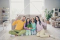 Photo of full family four members sit carpet dad mom hold paper roof children flower wear colorful jumper pants in