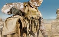 Soldier in uniform walking with backpack in desert Royalty Free Stock Photo