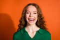 Photo of funky cheerful lady dressed green shirt showing stick out isolated orange color background