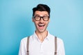 Photo of funky cheerful young man dressed white shirt spectacles open mouth isolated blue color background